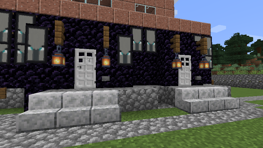 The front doors, the main entrance and the livestock room entrance, iron doors set against obsidian, and a lot of illiger banners